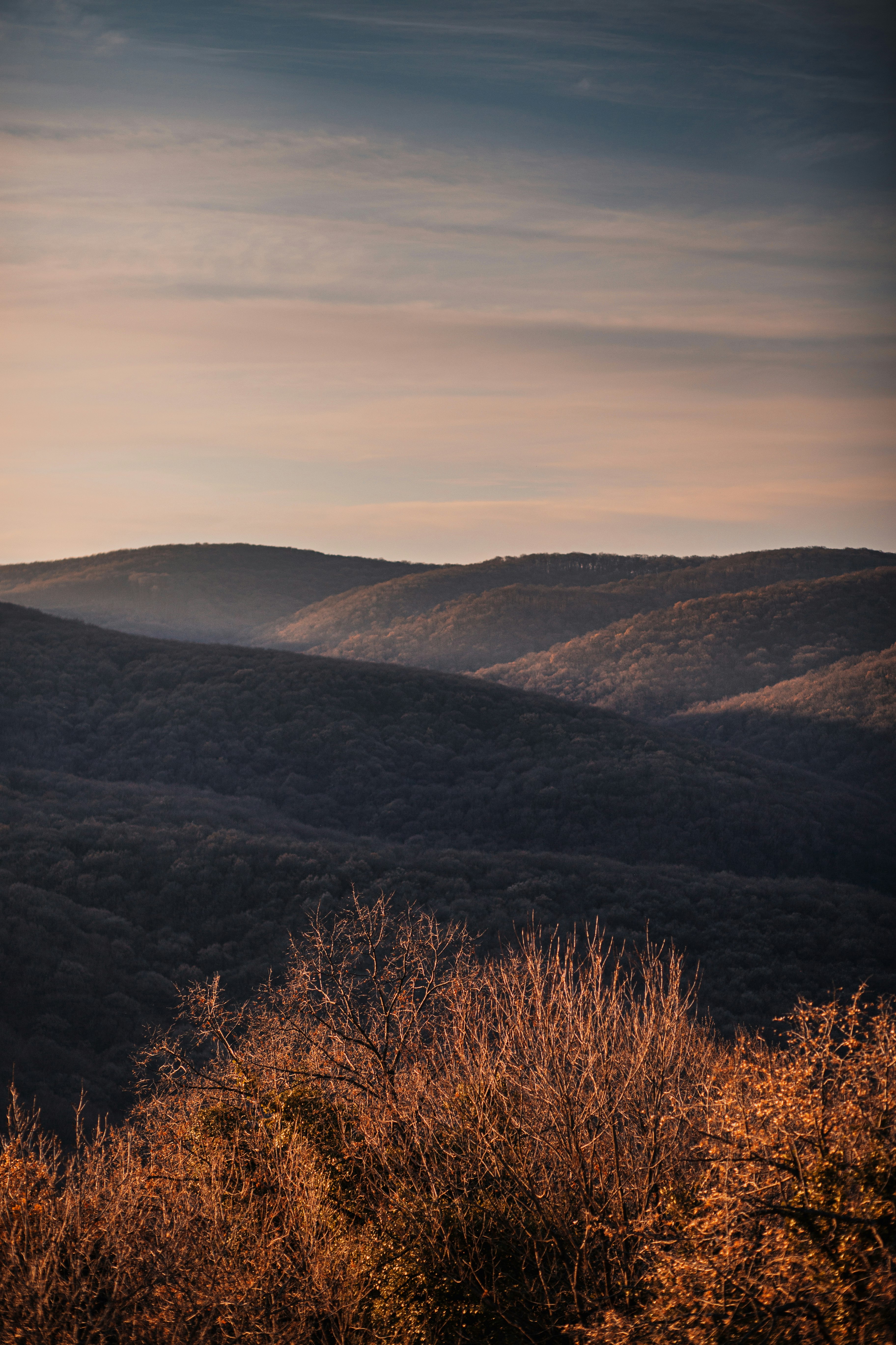 brown and green mountains under white sky during daytime